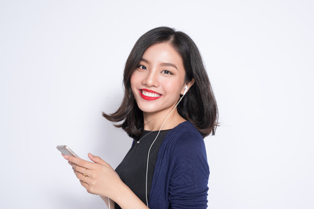 Young asian woman using smartphone isolated on white.の写真素材