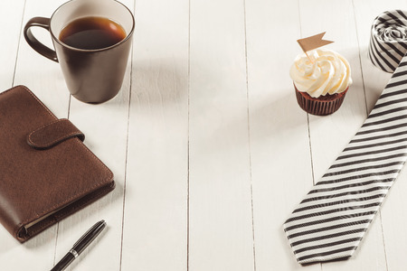 Fathers day concept. Delicious creative cupcake, tie on table.の写真素材