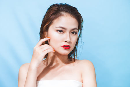 Tropical summer holiday fashion beauty concept. Summer style portrait of young attractive asian woman.の写真素材