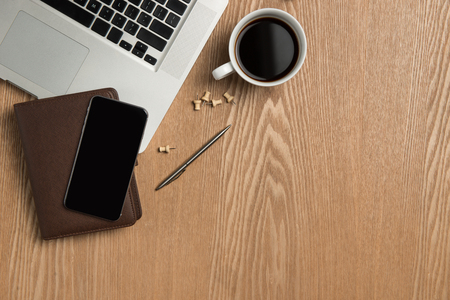 Business planning concept. Top view of hand writing on a blank notebook with hot coffee.の写真素材