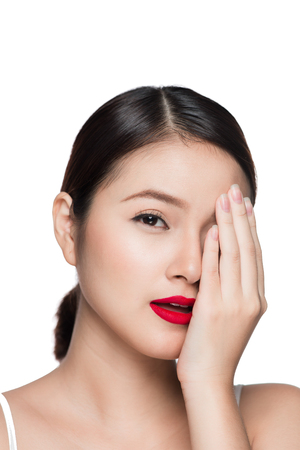 Beautiful asian woman with retro makeup with red lips isolated on white background.の写真素材