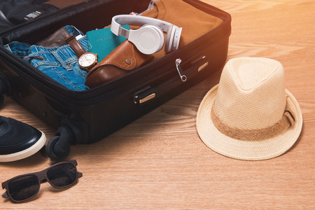 Travel and vacations concept. Open traveler's bag with clothing and accessories.の写真素材