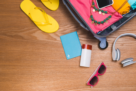 Travel and vacations concept. Open traveler's bag with clothing, accessories, credit card, tickets and passport.の写真素材
