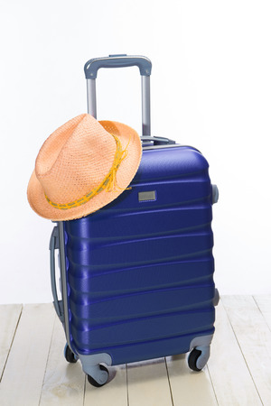 It's summer time. Travel bag and straw hat.の写真素材