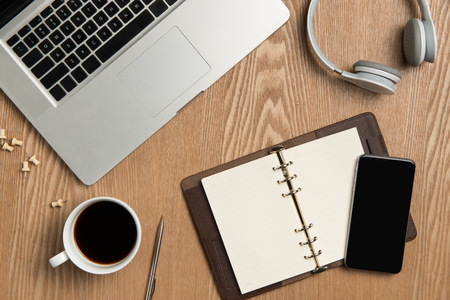 Business planning concept. Top view of hand writing on a blank notebook with hot coffee.の写真素材