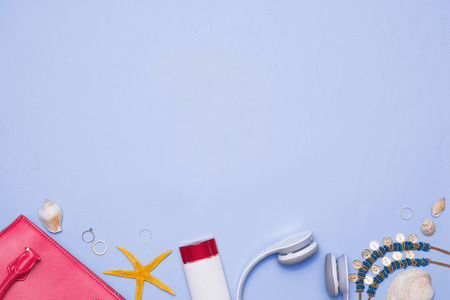 Summer concept. Pink handbag with accessories on light blue backgroundの写真素材