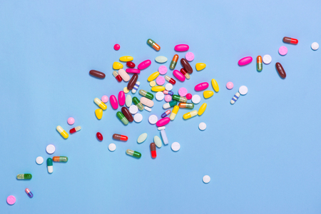 Colored pills on blue background.の写真素材