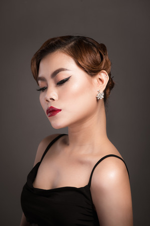 Portrait of beautiful sensual asian woman with elegant hairstyle and perfect makeup. の写真素材