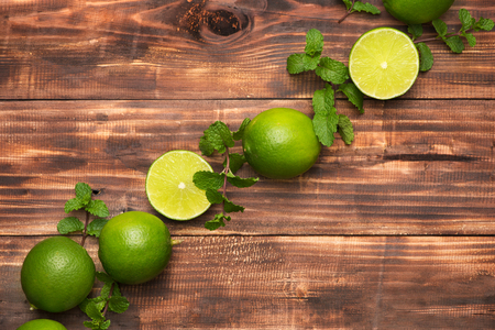 Fresh limes on wooden  table, Top view, background.の写真素材