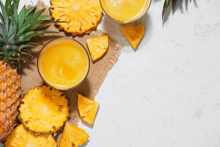Top view of fresh pineapple juice in the glass with pineapple fruitの写真素材