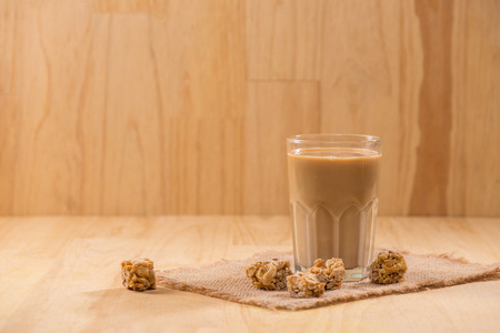 Coffee with milk on a wooden table.の写真素材