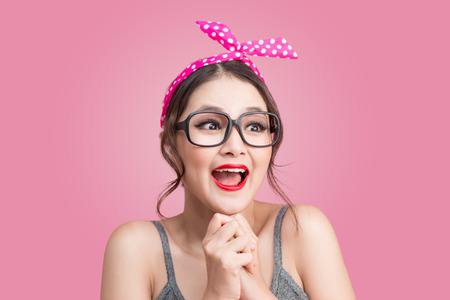 Surprised asian girl with pretty smile in pinup makeup styleの写真素材