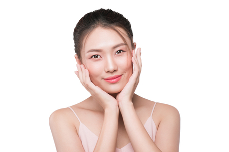 Healthy skin concept. portrait of beautiful woman model with fresh daily makeup looking at camera, touching her faceの写真素材