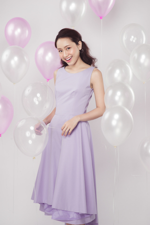 Asian pretty fashionable woman with pastel balloonsの写真素材