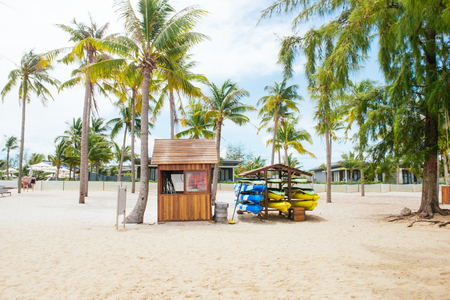 Life guard house on tropical beach with palm trees, blue sky and white sand.の写真素材