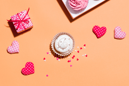 Delicious cupcake with paper box on yellow backgroundの写真素材