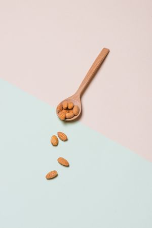 Almonds on light background. Almond nuts in spoon.の写真素材