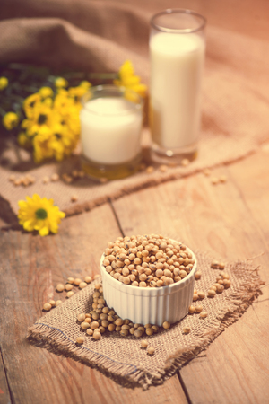 Soy milk or soya milk and soy beans on wooden table.の写真素材