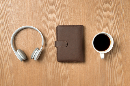 Office table with notepad, headphones and coffee. Top view with copy spaceの写真素材