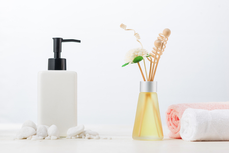SPA Decoration. Spa composition with cosmetic bottle and aromatherapy over white.の写真素材