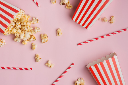 Popcorn in red and white cardboard box on the pink background.の写真素材