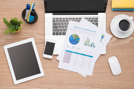 Financial concept. business earning report and financial chart and graph report on desk.の写真素材