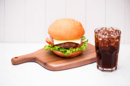 Homemade BBQ burger with coke on wooden background.の写真素材