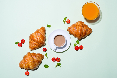 Breakfast with fresh croissants and orange juice, top viewの写真素材
