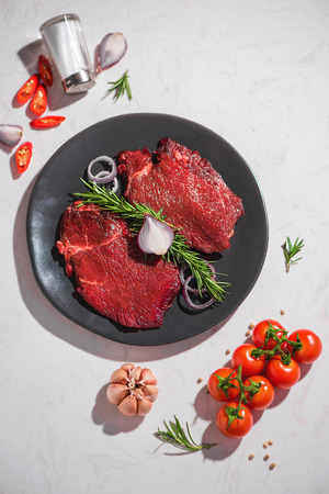 Raw fresh beef on white stone background, top viewの写真素材