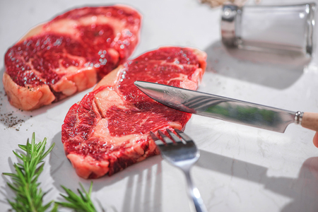 Raw fresh beef on white stone background, top viewの写真素材