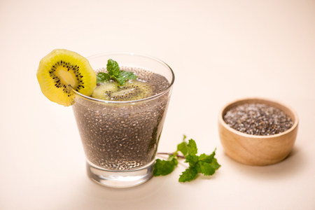 Selective focus of chia seeds drink with water in transparent glass with lemon balm.の写真素材