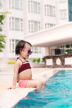 Little girl having fun in the pool. Summer holidays and vacation conceptの写真素材