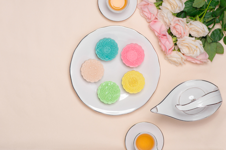 Sweet color of snow skin mooncake. Traditional mid autumn festival foods with tea on table setting.の写真素材