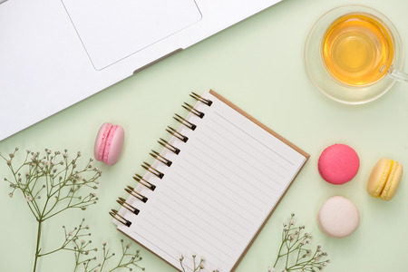 Flatlay of sweet macaroons and open notebook.の写真素材