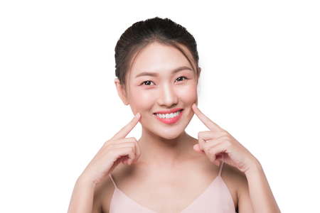 Healthy skin concept. portrait of beautiful woman model with fresh daily makeup looking at camera, touching her faceの写真素材