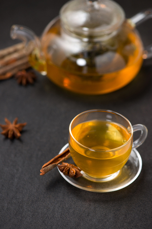 Cup of black tea with spices on white wooden background.の写真素材