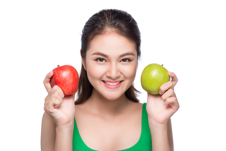 Portrait of asian woman holding red and green apple on white backgroundの写真素材