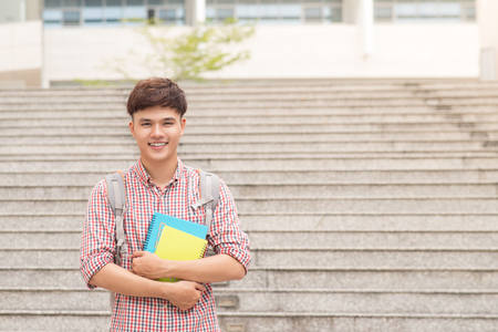 Asian student with his books in campusの写真素材