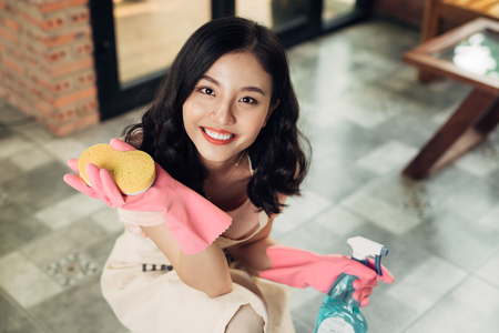 Housework and housekeeping concept. Woman cleaning floor with mop indoorsの写真素材