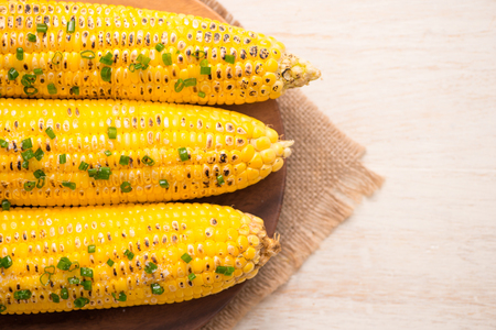 Tasty sweet grilled corn with onion sauceの写真素材