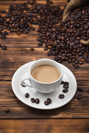 Coffee cup and beans on a rustic backgroundの写真素材