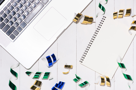 Celebration Flat lay with colorful party items and laptop on wooden background.の写真素材