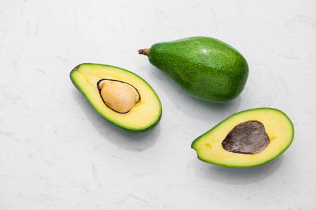 Healthy food concept. Fresh organic avocado on tableの写真素材