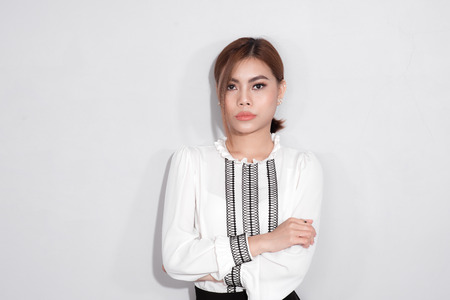 Portrait of beautiful asian woman holding a bag over gray background.の写真素材