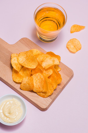 Concept of unhealthy food. Potato chips in a bowl and ketchupの写真素材
