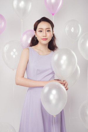 Asian pretty fashionable woman with pastel balloonsの写真素材