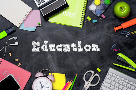 School stationery or office supplies on chalkboard background.の写真素材