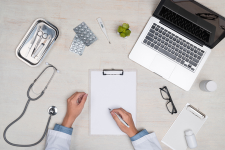 Top view of Medicine doctor hand working on the desk.の写真素材