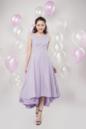 Asian pretty fashionable woman with pastel balloonsの写真素材