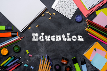 School stationery or office supplies on chalkboard background.の写真素材